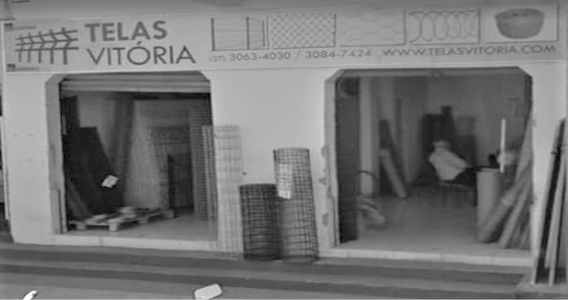 Fachada da loja Telas Vitória em preto e branco.